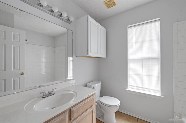 2706 E 28th St, Mission, TX 78574 - full bath with vanity, toilet, a shower, and tile patterned flooring