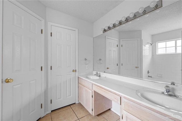 2706 E 28th St, Mission, TX 78574 - bathroom with double vanity, a textured ceiling, tile patterned flooring, and bathing tub / shower combination