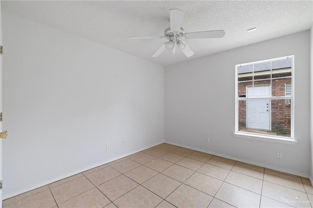 2706 E 28th St, Mission, TX 78574 - empty room featuring light tile patterned floors, a ceiling fan, a textured ceiling, and baseboards