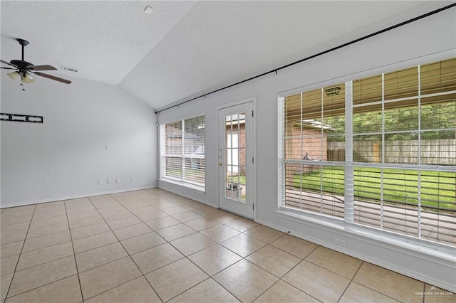 2706 E 28th St, Mission, TX 78574 - tiled spare room featuring lofted ceiling, a ceiling fan, baseboards, and a textured ceiling