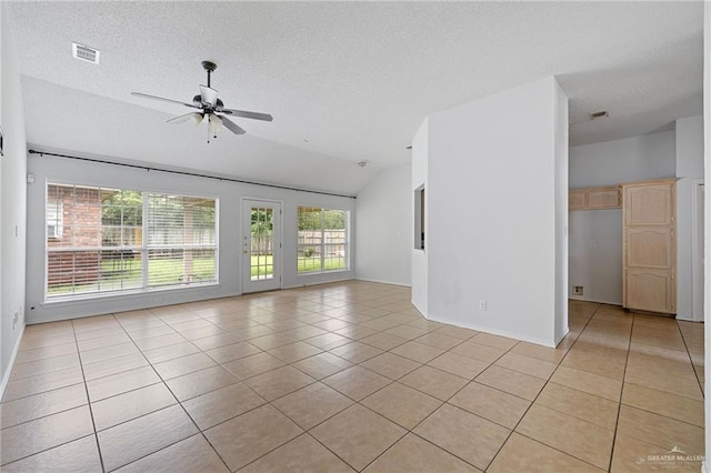 2706 E 28th St, Mission, TX 78574 - empty room with light tile patterned floors, lofted ceiling, a ceiling fan, a textured ceiling, and baseboards