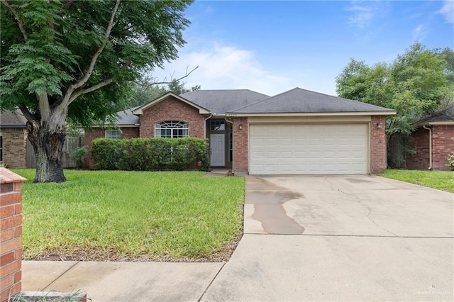 2706 E 28th St, Mission, TX 78574 - ranch-style home with concrete driveway, a front yard, a garage, and brick siding
