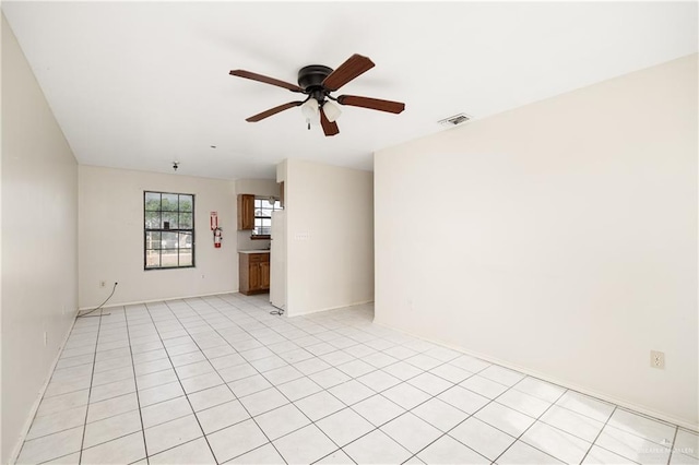 empty room featuring ceiling fan and light tile patterned flooring