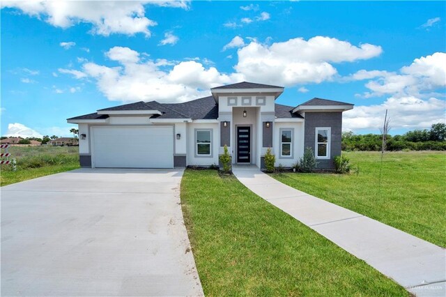 2501 Linva Ave, Mcallen, TX 78541 - prairie-style home with a front lawn, driveway, a garage, and stucco siding