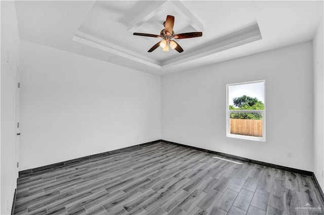 2501 Linva Ave, Mcallen, TX 78541 - spare room with ceiling fan, baseboards, wood finished floors, and a tray ceiling