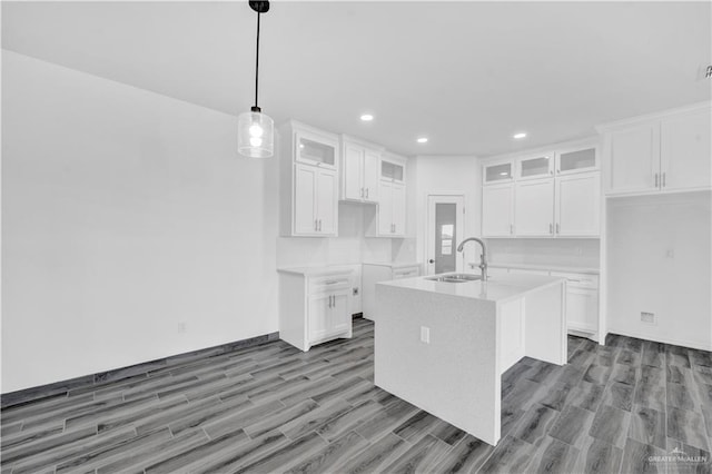 2501 Linva Ave, Mcallen, TX 78541 - kitchen featuring wood finished floors, recessed lighting, glass insert cabinets, and a sink