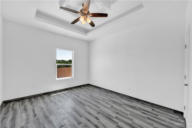 2501 Linva Ave, Mcallen, TX 78541 - spare room featuring wood finished floors, a raised ceiling, a ceiling fan, and baseboards
