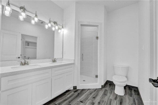 2501 Linva Ave, Mcallen, TX 78541 - bathroom featuring a stall shower, toilet, double vanity, and a sink