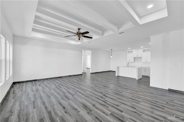 2501 Linva Ave, Mcallen, TX 78541 - unfurnished living room featuring a sink, ceiling fan, visible vents, baseboards, and wood finished floors