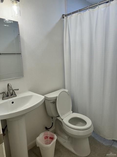 bathroom with sink, toilet, and a shower with shower curtain