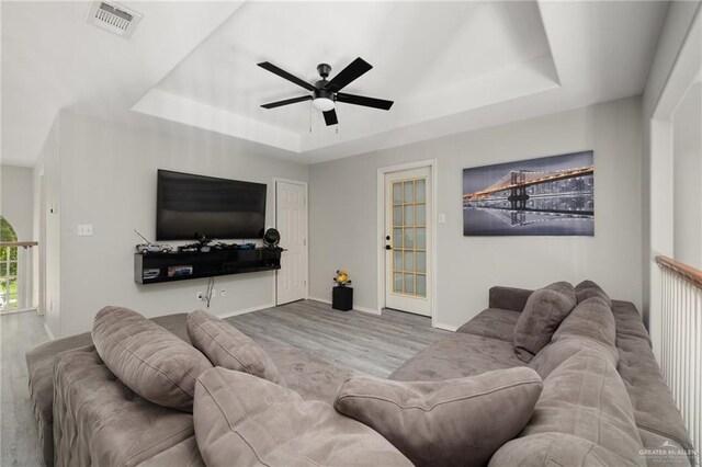 3500 Santa Lucia Cir, Mission, TX 78572 - living area with a tray ceiling, ceiling fan, wood finished floors, and baseboards