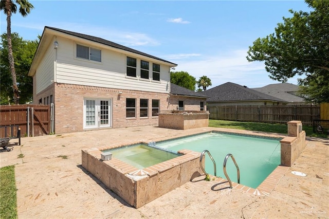3500 Santa Lucia Cir, Mission, TX 78572 - rear view of house with brick siding, an in-ground hot tub, french doors, a fenced backyard, and a patio area