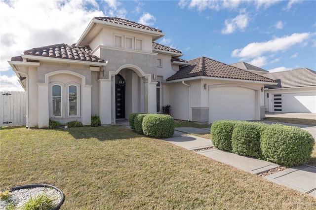 mediterranean / spanish-style house featuring a garage and a front lawn