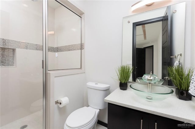 bathroom with vanity, a shower with shower door, and toilet