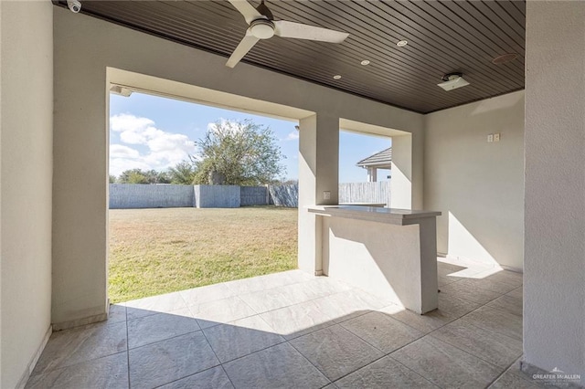 view of patio with an outdoor bar and ceiling fan