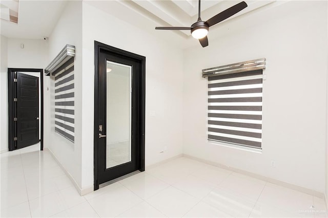 unfurnished room featuring ceiling fan and light tile patterned flooring