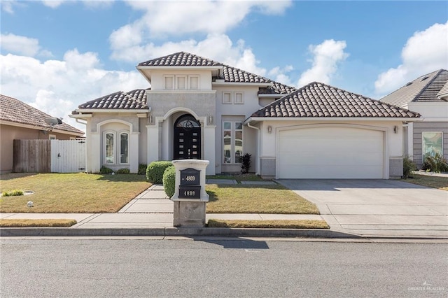 mediterranean / spanish home featuring a garage and a front lawn