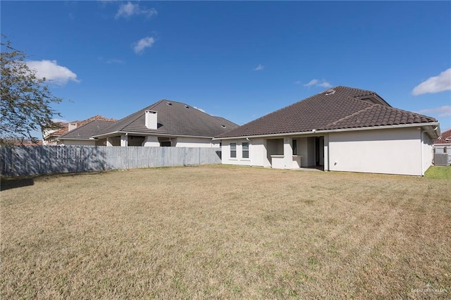 back of house with a lawn