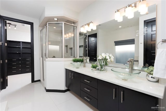 bathroom with vanity, an enclosed shower, and tile patterned flooring