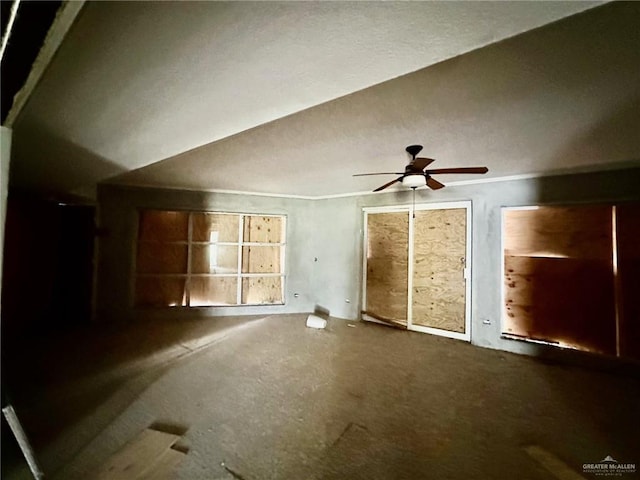 unfurnished living room with carpet and ceiling fan