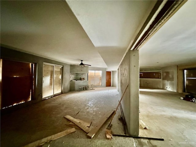 unfurnished living room featuring a ceiling fan