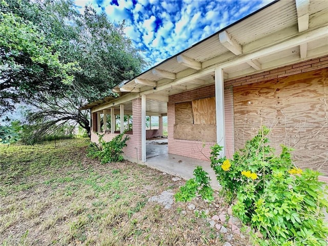 exterior space featuring brick siding