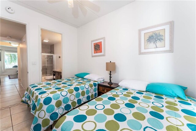 5909 Padre Blvd Unit 201, South Padre Island, TX 78597 - bedroom with light tile patterned floors, ensuite bath, and ceiling fan