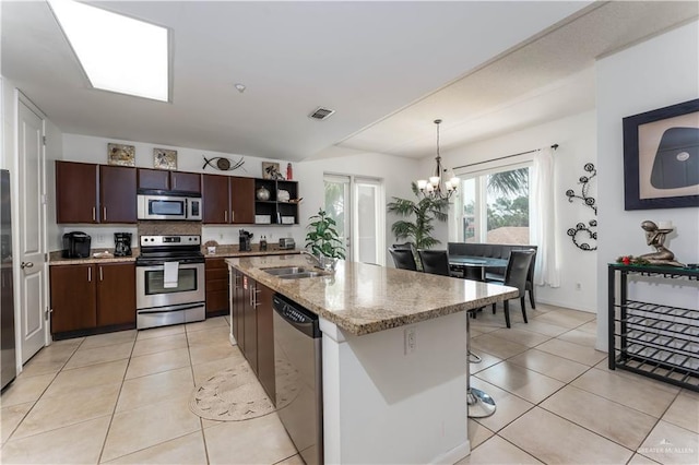 5909 Padre Blvd Unit 201, South Padre Island, TX 78597 - kitchen with stainless steel appliances, a sink, a chandelier, and light tile patterned floors