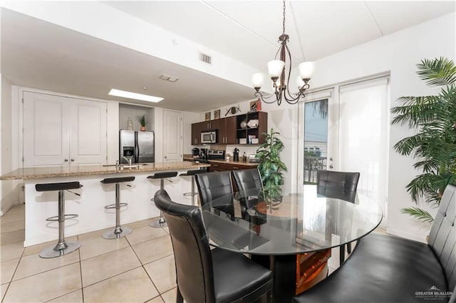 5909 Padre Blvd Unit 201, South Padre Island, TX 78597 - dining space featuring a chandelier and light tile patterned floors