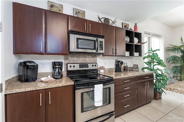 5909 Padre Blvd Unit 201, South Padre Island, TX 78597 - kitchen with appliances with stainless steel finishes, open shelves, light tile patterned floors, and dark brown cabinets