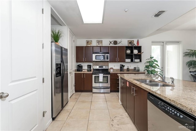 5909 Padre Blvd Unit 201, South Padre Island, TX 78597 - kitchen featuring stainless steel appliances, a sink, dark brown cabinets, open shelves, and light tile patterned flooring
