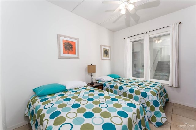 5909 Padre Blvd Unit 201, South Padre Island, TX 78597 - tiled bedroom featuring access to outside, ceiling fan, and baseboards