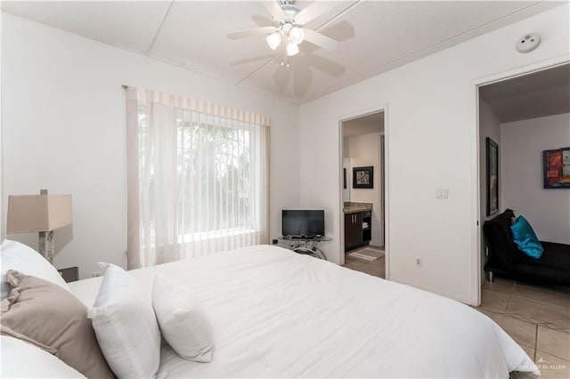 5909 Padre Blvd Unit 201, South Padre Island, TX 78597 - bedroom with light tile patterned floors, ensuite bath, and a ceiling fan