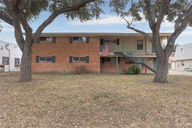 back of property featuring a lawn