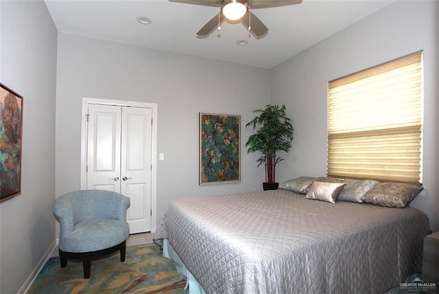 bedroom with ceiling fan and a closet