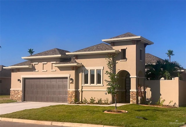 prairie-style house with a garage and a front lawn