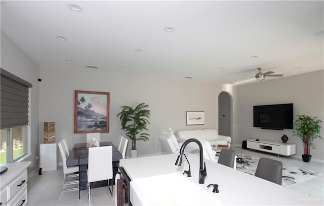 kitchen featuring white cabinetry, sink, ceiling fan, and light tile patterned floors