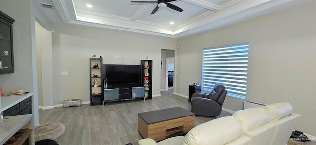 living area featuring coffered ceiling, visible vents, a ceiling fan, ornamental molding, and light wood finished floors