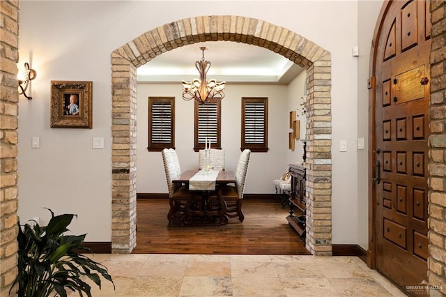 1509 Duke Ave, Mcallen, TX 78504 - dining room with a chandelier, arched walkways, and a tray ceiling