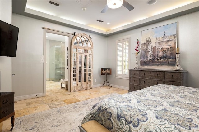 1509 Duke Ave, Mcallen, TX 78504 - bedroom featuring a tray ceiling, stone finish flooring, and connected bathroom
