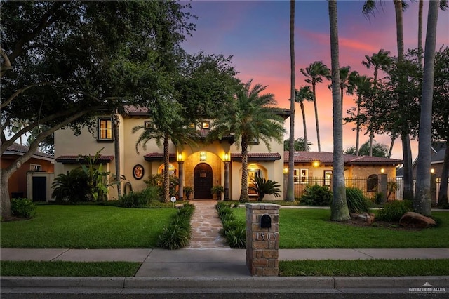 1509 Duke Ave, Mcallen, TX 78504 - mediterranean / spanish house with a front yard, stucco siding, and a tile roof