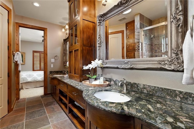 1509 Duke Ave, Mcallen, TX 78504 - bathroom featuring double vanity, a stall shower, connected bathroom, stone finish flooring, and recessed lighting