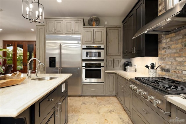 1509 Duke Ave, Mcallen, TX 78504 - kitchen with ventilation hood, stainless steel appliances, recessed lighting, pendant lighting, and a chandelier