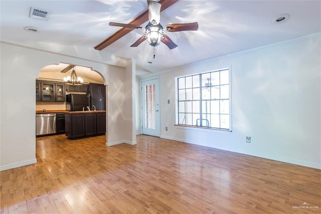 unfurnished living room featuring ceiling fan with notable chandelier, ornamental molding, lofted ceiling with beams, and light hardwood / wood-style flooring