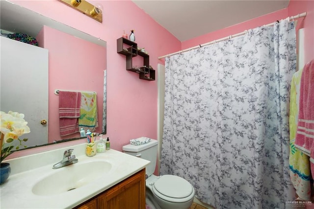 full bathroom with toilet, curtained shower, and vanity