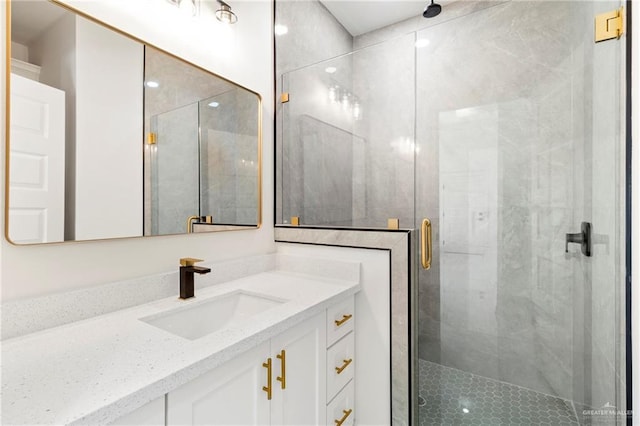 bathroom with a shower stall and vanity