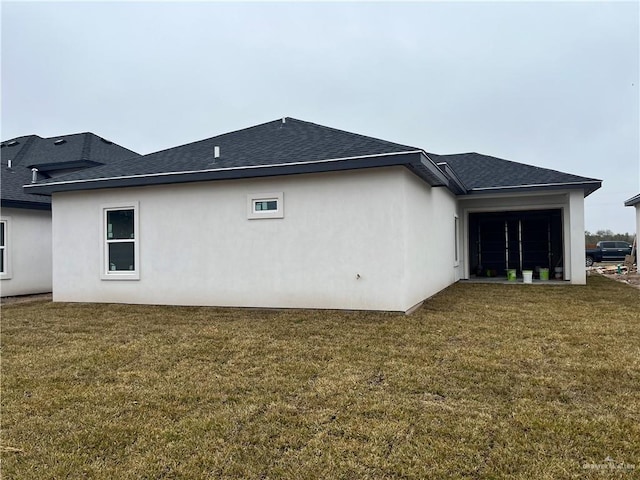 rear view of property featuring a yard