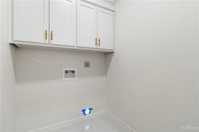 laundry area with cabinet space, baseboards, and washer hookup