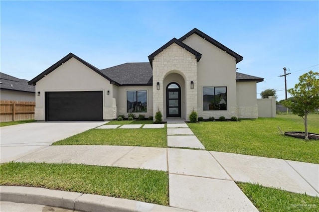 5112 W Burberry St, Edinburg, TX 78541 - french provincial home featuring stone siding, an attached garage, concrete driveway, and stucco siding