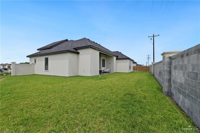 5112 W Burberry St, Edinburg, TX 78541 - back of property featuring a fenced backyard, roof with shingles, and stucco siding